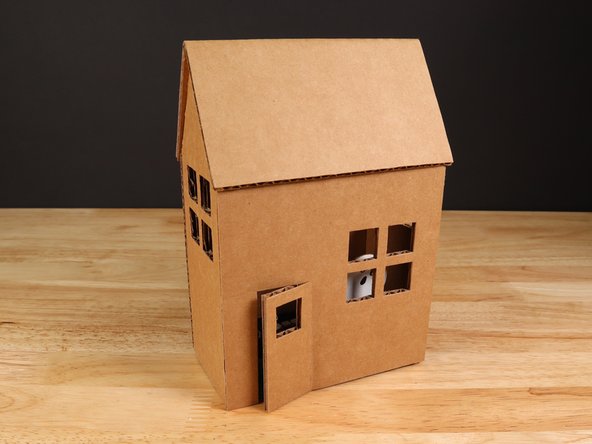You may need to adjust the wires so they fit under the back panel of the house.
