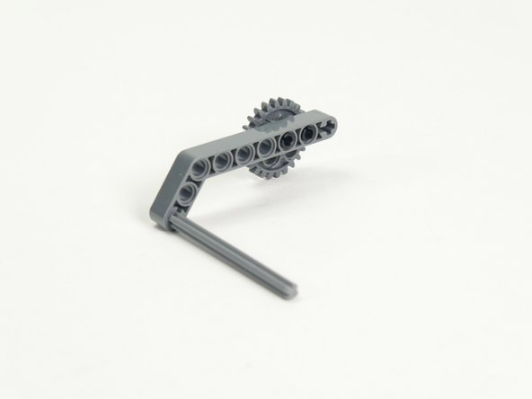 Next add the axle with end stop to the end of the angled beam.