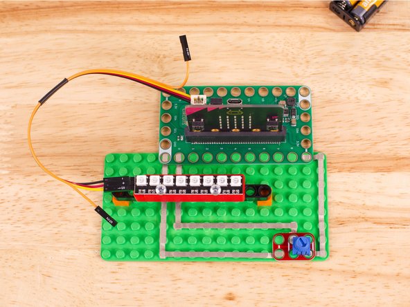 Use the Crazy Circuits Ribbon Cable to connect the NeoPixel Strip to the Bit Board.
