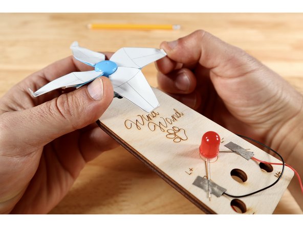 There are several lines in the area labeled &quot;c&quot; on the template card diagram. Choose one line near the blade tip to fold on and repeat for all four blades.