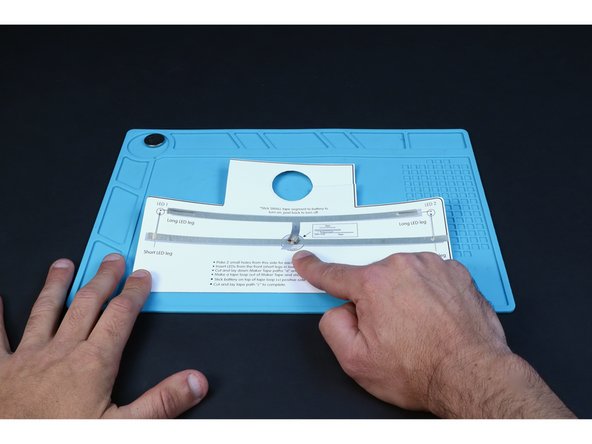 Stick the tape loop atop the middle point of the tape path that crosses the battery.
