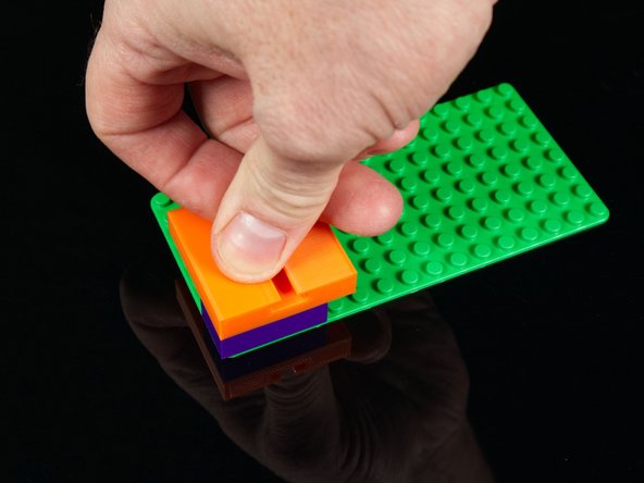 To attach LEGO bricks to the Track we like to place the bricks onto a baseplate and the press down on the Track so it snaps into place.