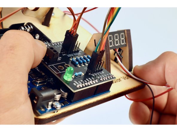Note the color of the wire that is already plugged in and second from the top   (yellow in our photo...but yours may be a different color). Find the opposite end of that wire and plug it into the analog pin labeled A1 on the Arduino shield.