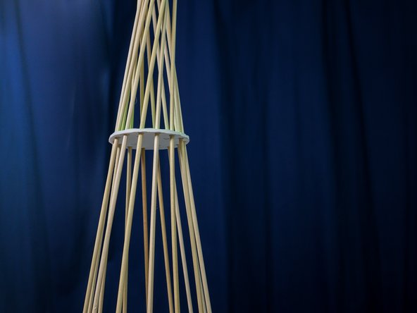 Push the circle down until the dowels form a point at the top.