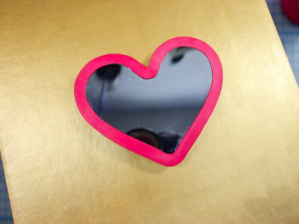 Then position the heart box over the mirror paper heart and glue it in place. Remove any excess glue from the outside of the heart.