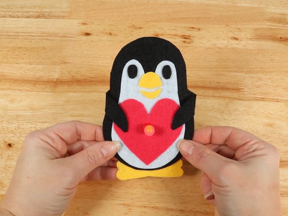 If you are using Elmers or Tacky glue, you will need to use something to hold the paws in place until it dries. Binder clips work well for this.