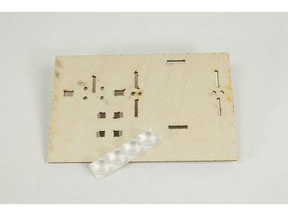 Flip the base upside down so we can add the four large rubber feet to the bottom.