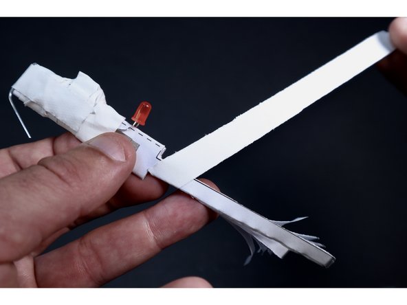 Start another piece of gaff/duct tape at an angle right where the narrow section begins. Spiral wrap all the way to the end, bringing all those frills together into a tidy package.