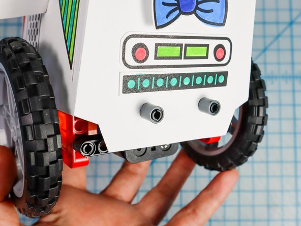 Use the pin/beam pieces to attach the body to the rover as shown. There is a connection behind the wheel on both sides and there are two connections in the front.