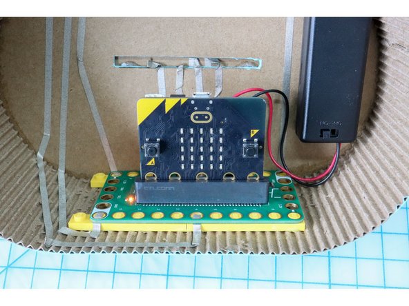 Use foam tape to mount the battery holder inside the guitar.