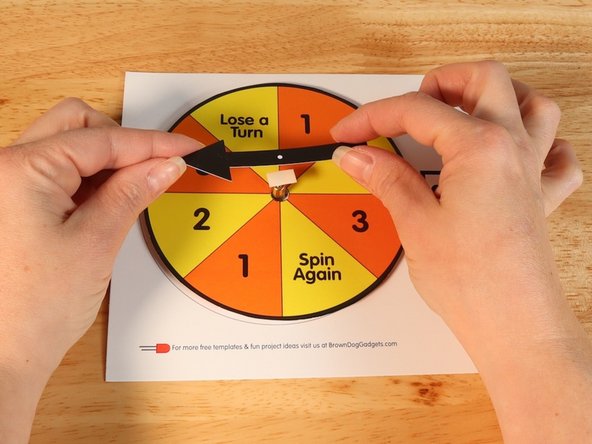 Add another square of double-sided tape onto the shaft of the motor, and then stick the arrow to it.