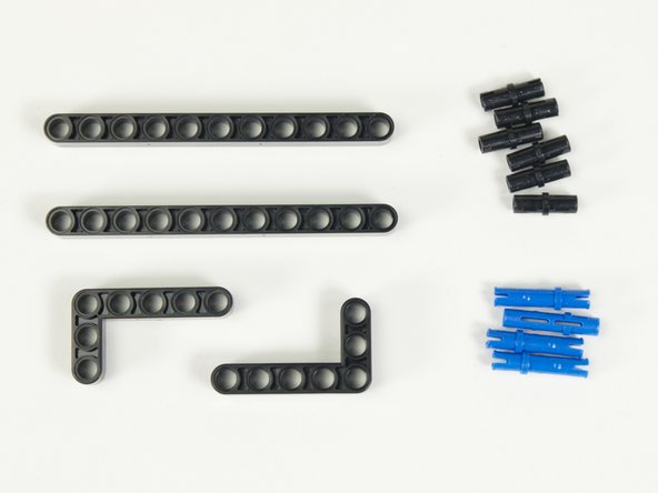 We'll use two long black beams to connect the servos together into a frame, and then two L-shaped black beams to stabilize the frame a bit more.