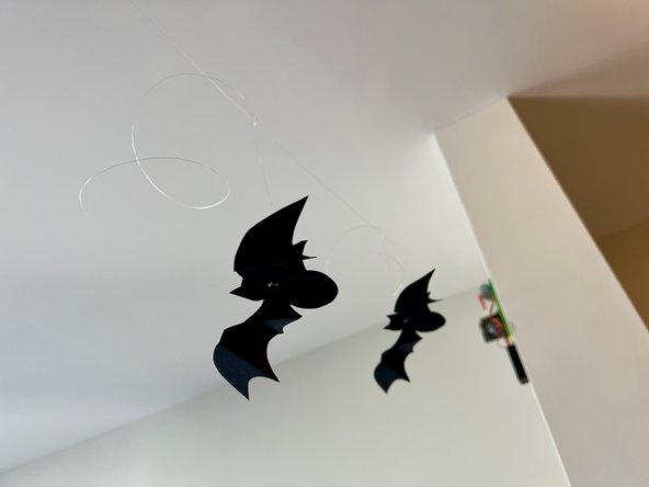 Tie the bat strings to the main string letting the bats hang at different lengths. Tie the smaller bats higher and the larger bats lower to give the appearance of depth.