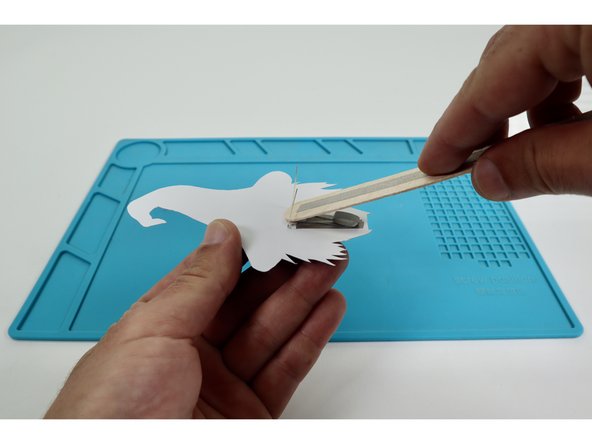 Seat one end of the wand handle between the two outer LED legs and press into place so that the Maker Tape Loop contacts the downward-facing path of the wand handle.