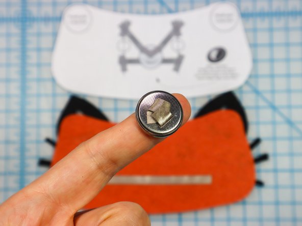Make a loop of Maker Tape with the adhesive side out and place it on the negative side of the battery.