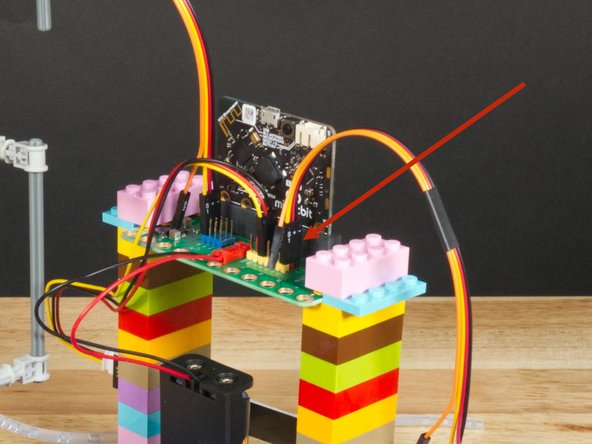 Since the Crazy Circuits Ribbon Cable has a connector on one end that combines three wires together you'll want to plug that end into the Bit Board. The Yellow wire will get plugged in and the Orange wire will be dangling on its own.