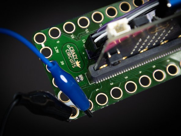 Using alligator clips, connect one side of each switch to ground, and the other to pin 0, 1, 2, and/or 3. In the example code, we connected all of the switches at once.