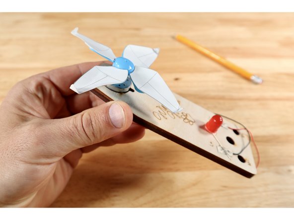 There are several lines in the area labeled &quot;c&quot; on the template card diagram. Choose one line near the blade tip to fold on and repeat for all four blades.