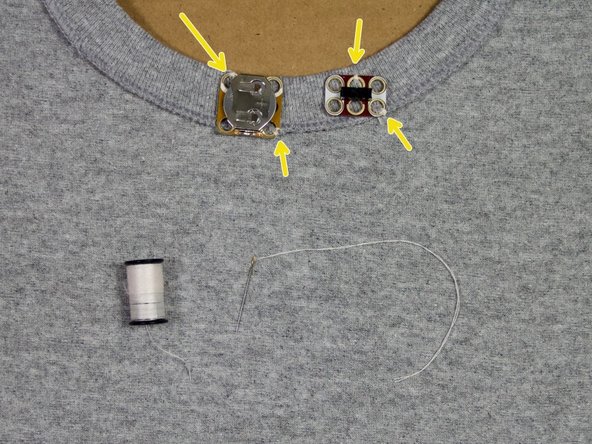 Use a needle and thread to tack the board in place where shown.