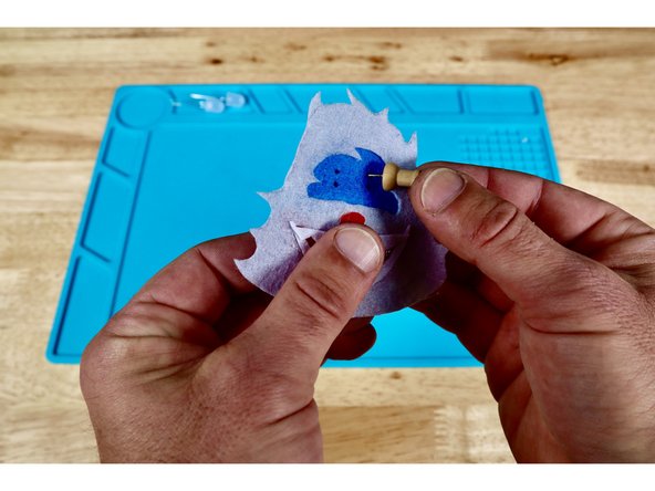 Each LED eye will have two wire &quot;legs&quot; that are difficult to push through the felt by themselves. To make this easier, make two dots for each LED where you want the eyes to be; oriented vertically as shown in photo one.