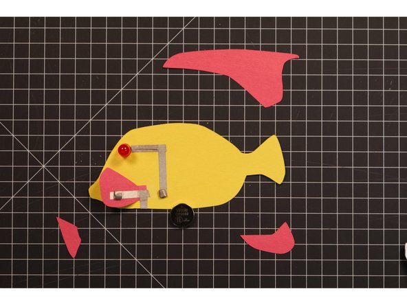 We’re going to make two small tape loops using Maker Tape. One will hold the battery down to the negative tape line, while the other will hold the fin down to the top (positive side) of the battery.