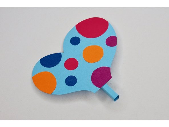 Glue the tabs of the wing holder onto the wing.