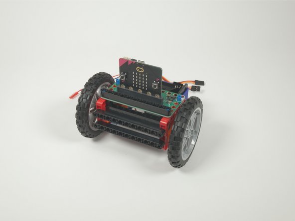 We'll add a long black beam onto the blue pins on the front of the Bit Board. This will help hold it securely in place.