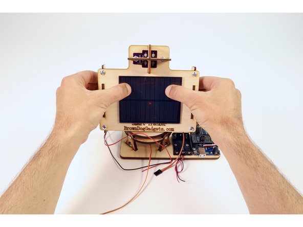 Pull the wires the rest of the way through and press the Solar Panel in place atop the mounting plate as shown.