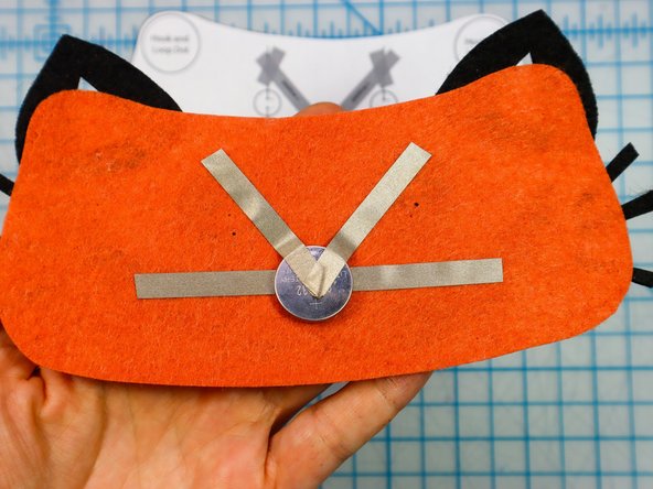 Place the battery on top of the Maker Tape as shown, and add the &quot;V&quot; shaped piece on top.