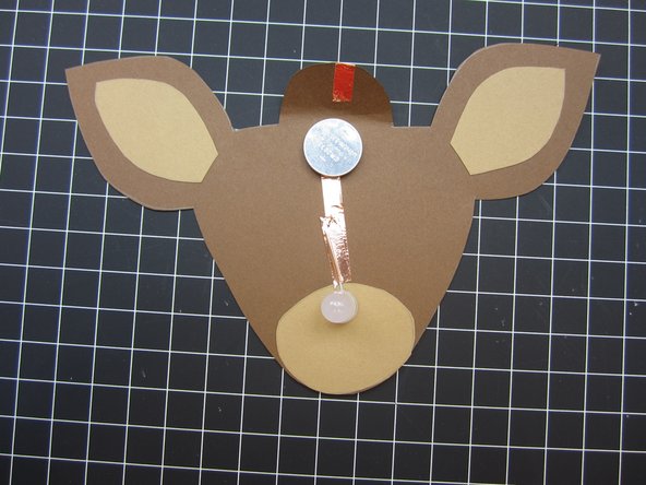 Place a battery so that bottom (Negative) side is over the Negative line of tape.  (Top side)