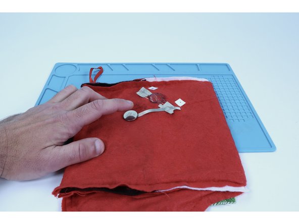 Stick your battery atop the tape loop so that the positive (+) side faces UP.