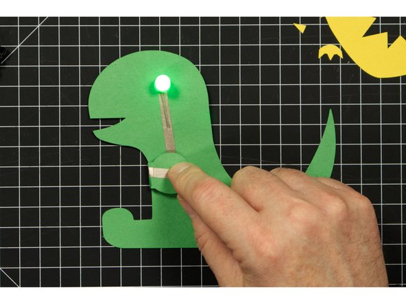 Place the battery so that bottom (negative) side is over the negative line of tape.