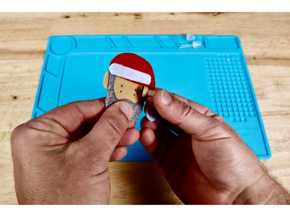 Each LED eye will have two wire &quot;legs&quot; that are difficult to push through the felt by themselves. To make this easier, make two dots for each LED where you want the eyes to be; oriented vertically as shown in photo one.