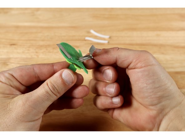 Peel and stick half of each piece of Maker Tape to a single LED leg and then fold the remaining halves back onto themselves to effectively sandwich each leg between a single folded piece of Maker Tape.
