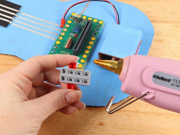 Add hot glue or another strong glue to the bottom of the LEGO plates.