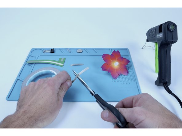 Measure and cut two Maker Tape segments that are 1-2&quot; long. These will be used to connect each of the LED legs to the paths on either side of the stem.