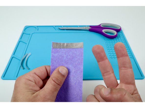 Use the pieces you just cut to create a pad at the end of one side of the band.  The two pieces should overlap one another a tiny bit.