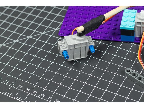 To attach our mallet servo onto our arm servo  we use three more parts: