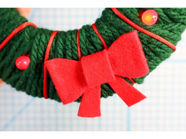 Then, I used the template to make a felt bow, hot gluing it together and then gluing it to the wreath.