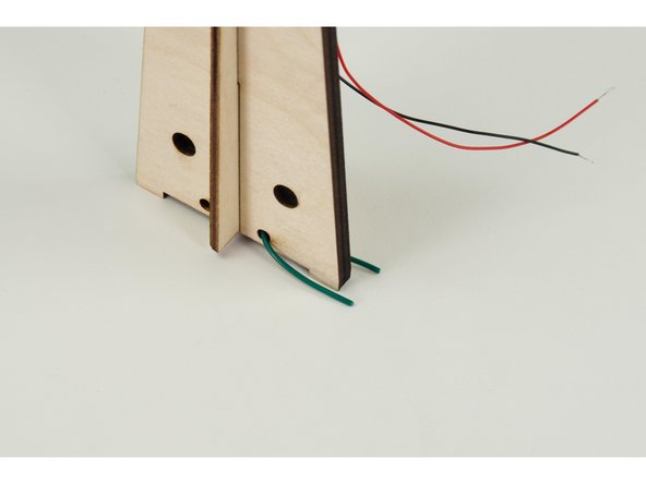 Take another short piece of wire and bend it into a &quot;U&quot; shape, then thread it through a hole in the bottom of the windmill assembly.