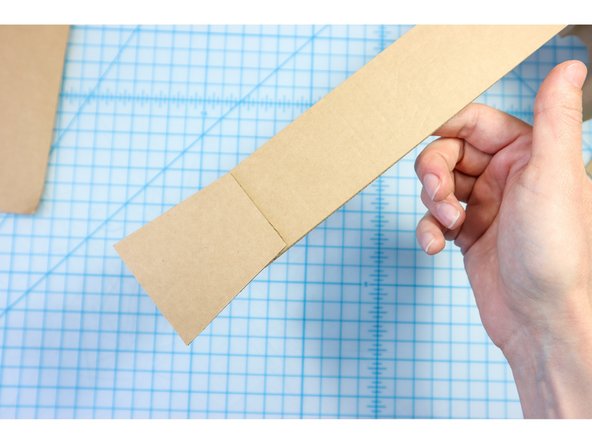 Glue the head piece to the top of the neck and paint the guitar with craft paint.