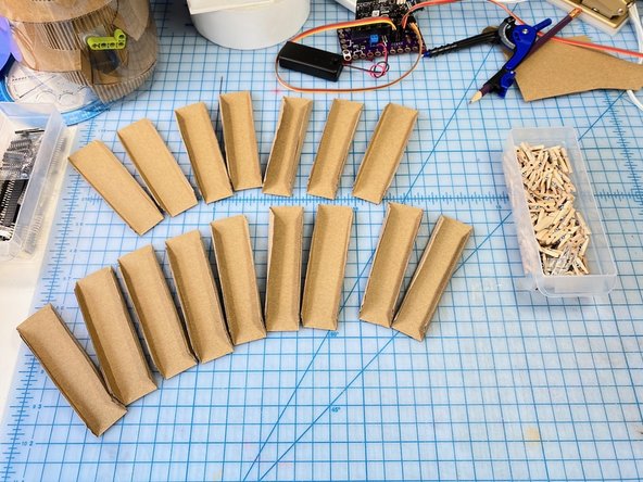 We cut out 16 of these shapes with a 1/4 inch extra on the edges to glue them together and create the vertical lines.