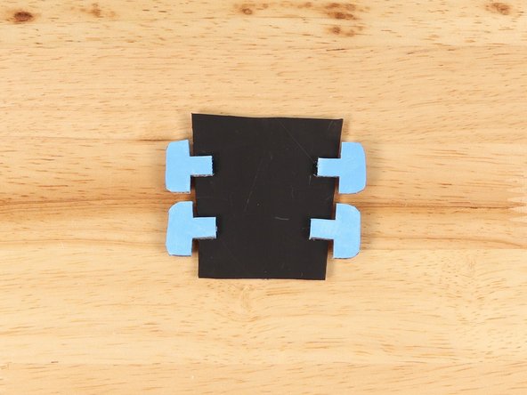 Using hot glue or another strong glue, attach the tuning pins to the head.