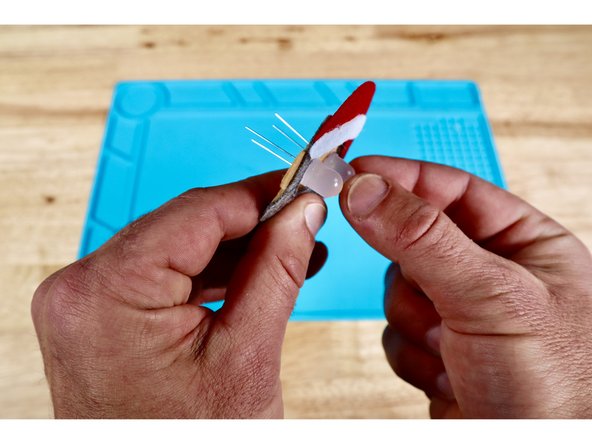 Use a pushpin to make a hole where each marked dot is located. There will be four holes in total.