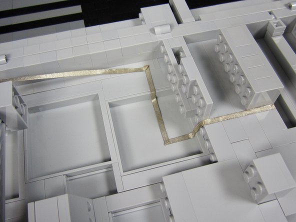 Run a very long line of tape from a Ground connection on the Invention Board all the way to the end of the board.