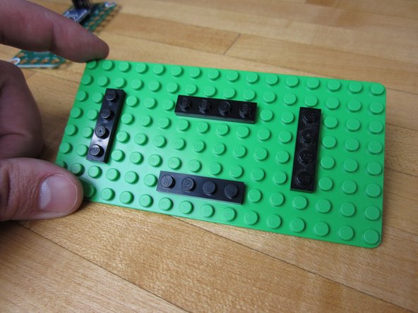 We threw on some 1x4 plates onto our 8x16 LEGO base plate in order to hold the Robotics Board in place before putting things in our box.