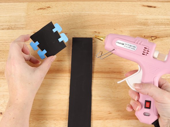 Using hot glue or another strong glue, attach the head to one end of the neck.