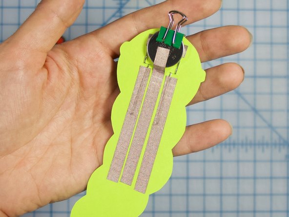 Stick the shorter, 2.5 inch pieces over each of the LEDs positive legs. All three pieces of tape should be parallel to each other and not touching.