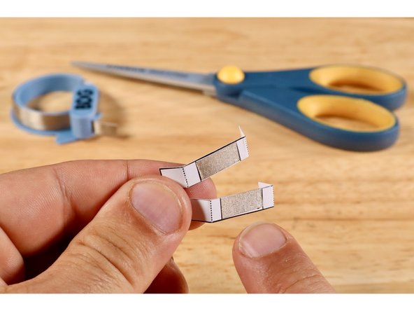 Measure, cut, peel, and stick a piece of Maker Tape where shown on each of the two switch templates.