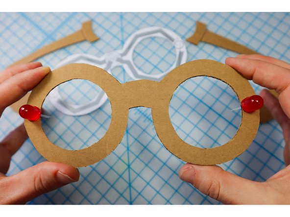 Push the LEDs through the holes on the frames, with the Positive (Long Leg) facing away from the center.